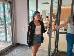 girl entering library from starbucks holding coffee